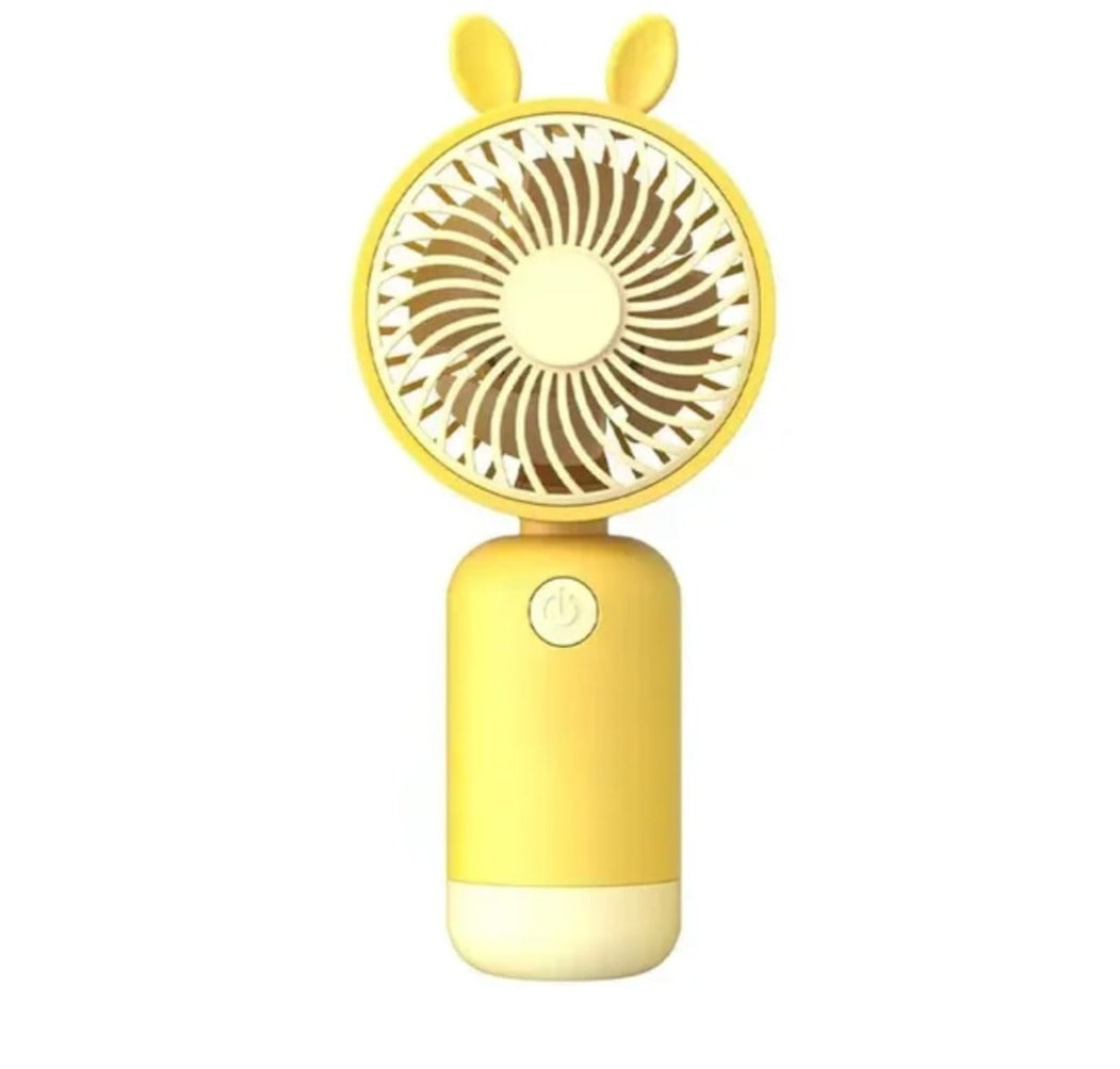 A mini yellow fan. Its standing upright. 